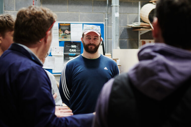Male teachers and students engaged in conversation at Herefordshire College