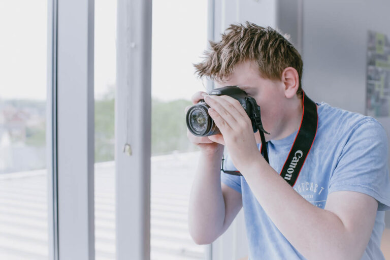 A male student uses a canon camera at the HLNSC North Shropshire College.