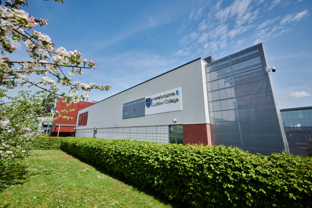 Herefordshire campus building with crest and logos on