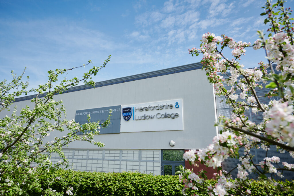Herefordshire campus building with crest and logos on