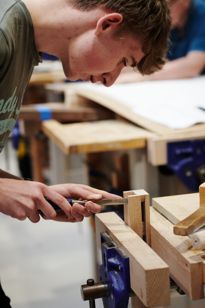 student working on his project in carpentry class