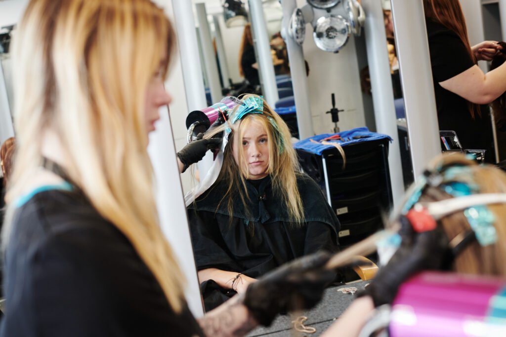 student working on a client's hair at Herefords hair and beauty studio