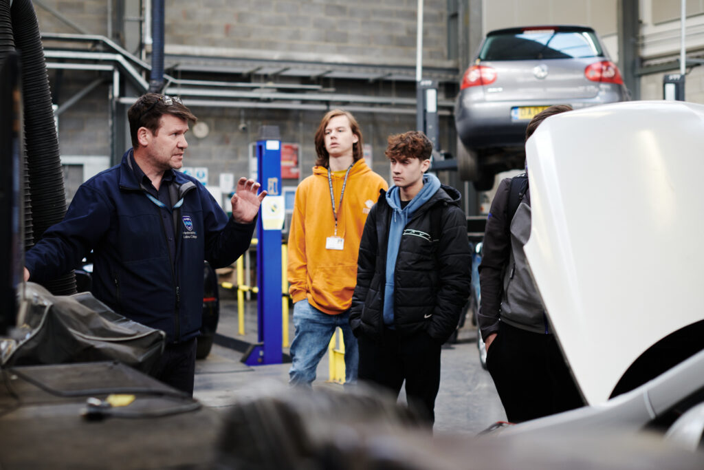 motor vehicle lecturer talking to his students