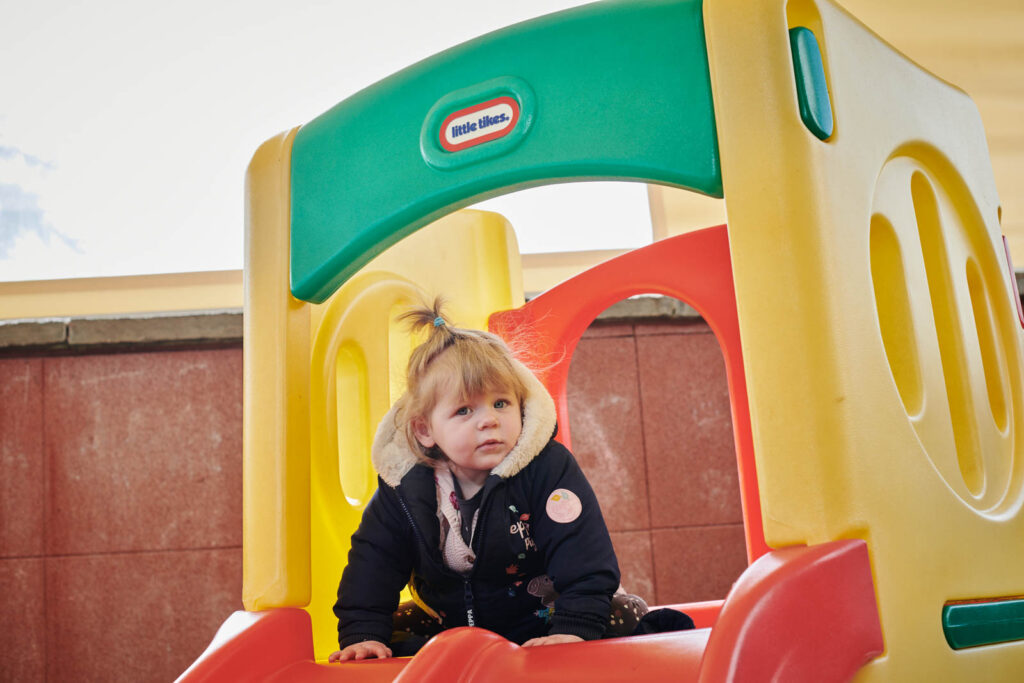 a young child playing on the campuses playground