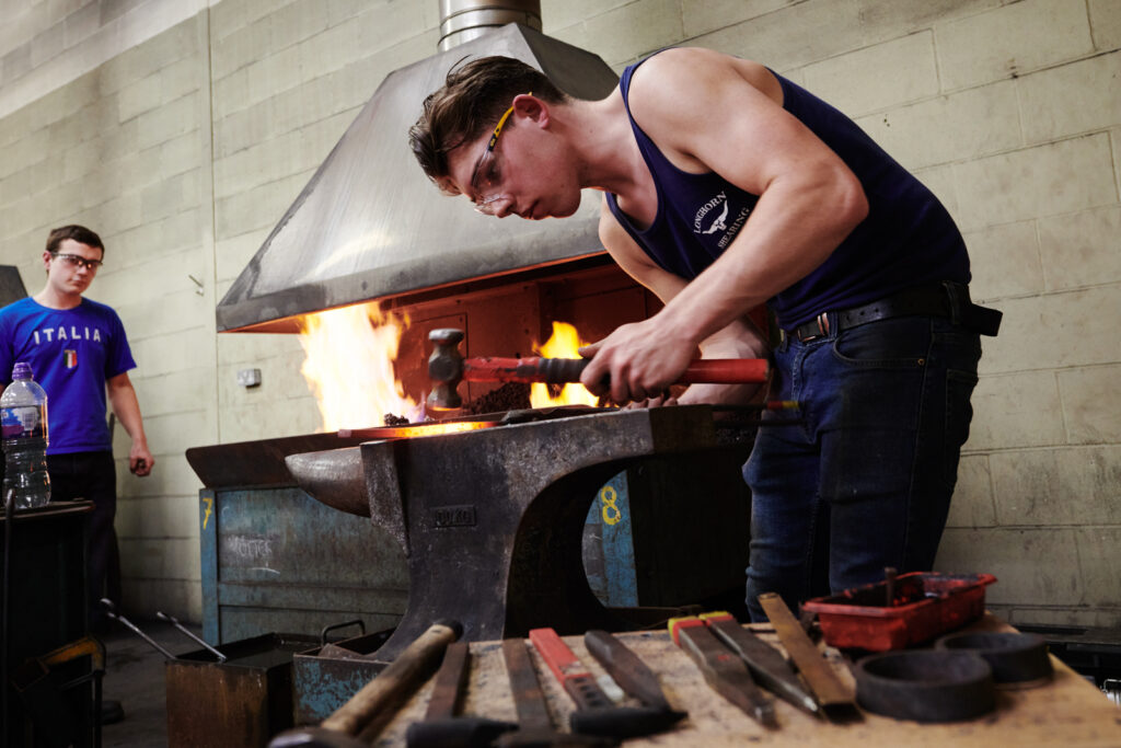 student using hammer and anvil