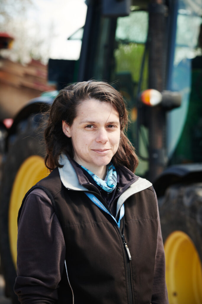 Woman in front of tractor