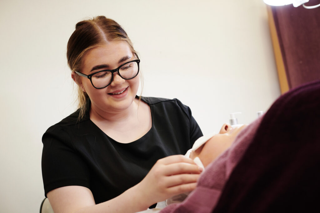 A beauty student practising providing a facial treatment at North Shropshire College