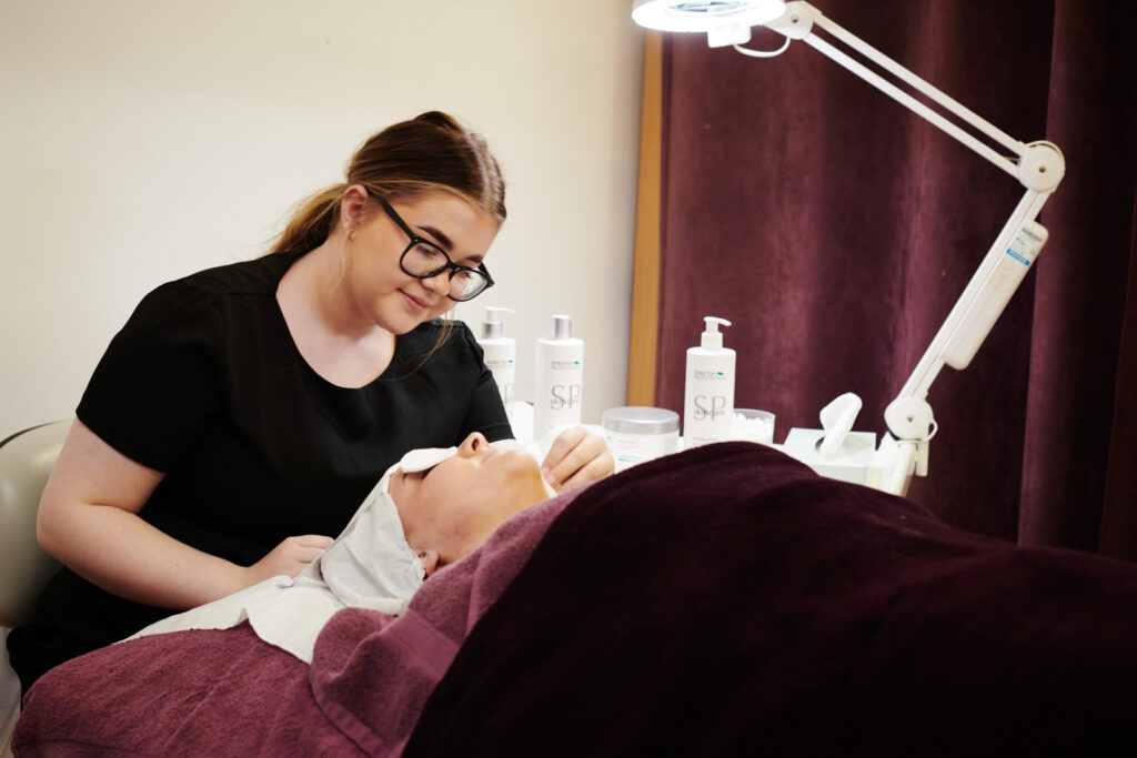 A beauty student practising providing a facial treatment at North Shropshire College