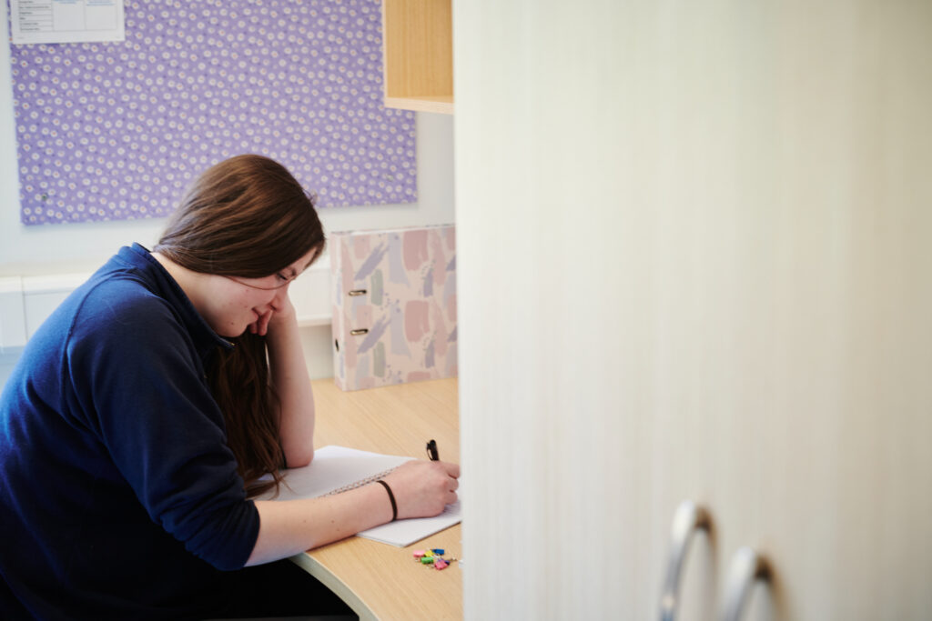 a student revising in a dorm room at Walford accommodation