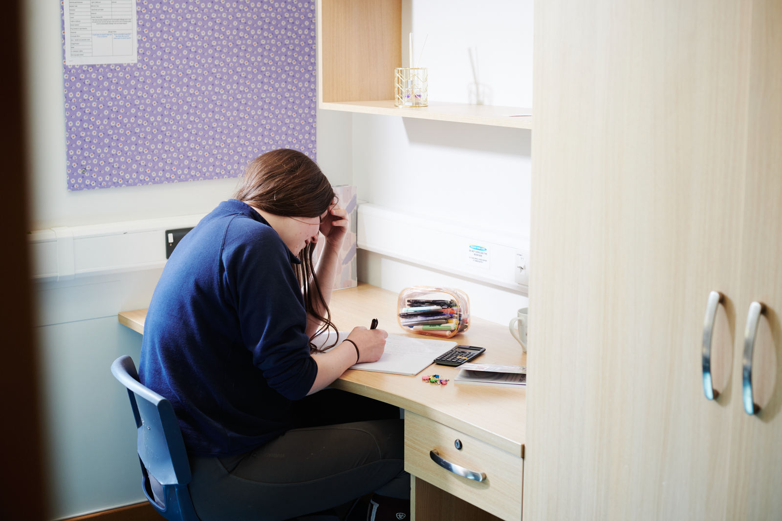 a student revising in a dorm room at Walford accommodation