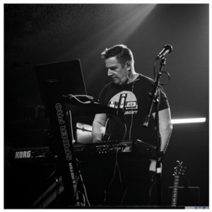 Black and white image of Herefordshire College Tutor Dan Armstrong performing at a gig