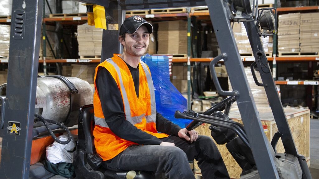 Student smiling sat in a forklift truck