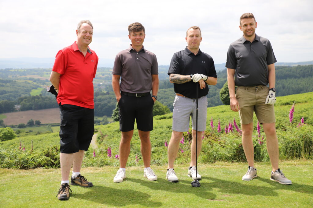 Team of four men enjoying a charity golf day