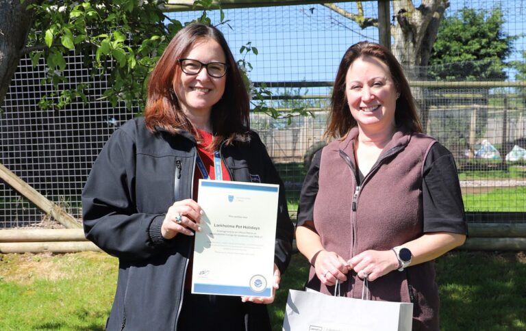 Patron holding a certificate