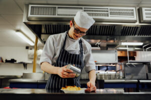 Hospitality students plating restaurant-quality meals during training