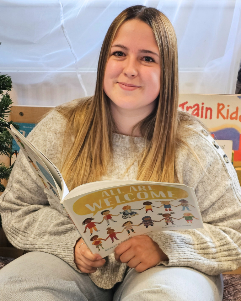 Kerris Early Years Student sat with Book